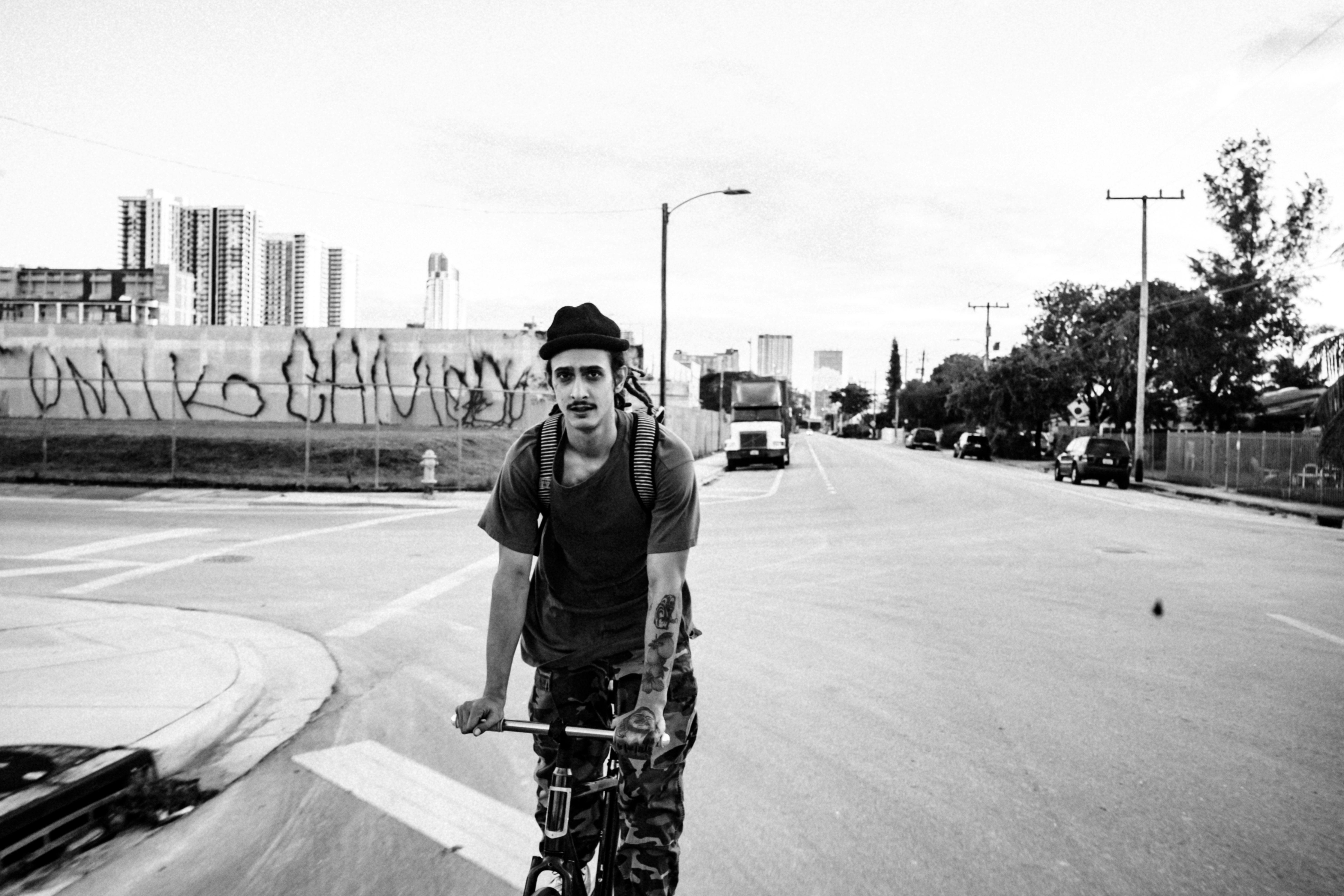 man in black t-shirt riding bicycle on road during daytime